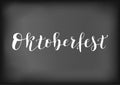 Modern calligraphy of Oktoberfest in white on black background stylized as chalk lettering