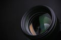 Modern camera lens on black background, closeup. Space for Royalty Free Stock Photo