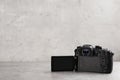 Modern camera on light grey stone table, space for text. Video production industry Royalty Free Stock Photo