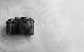 Modern camera on light grey stone table, top view with space for text. Video production industry Royalty Free Stock Photo