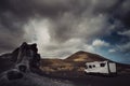 Modern camper van camp site in a scenic landscape destination with mountains and cloudy sky in background. Van life alternativ Royalty Free Stock Photo