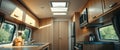 Modern camper van kitchen interior with sunlight streaming through windows. Bright and airy space with wood cabinets and Royalty Free Stock Photo