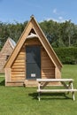 Modern camping pods and table in a field.