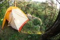Modern camping tent in forest at summer, space for text. Fisheye lens effect Royalty Free Stock Photo