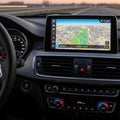 Modern car dashboard with GPS navigation system displaying map during travel Royalty Free Stock Photo