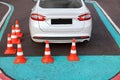 Modern car on driving school test track with traffic cones, above view Royalty Free Stock Photo