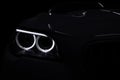 Modern car headlight on black background. Royalty Free Stock Photo