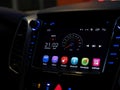 Modern car interior dashboard touch display closeup, Android auto touchscreen monitor panel inside the vehicle at night, detail Royalty Free Stock Photo