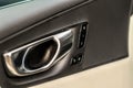 Modern car interior door handle close up.