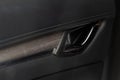 Modern car interior door handle close up. Royalty Free Stock Photo