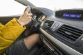 Modern car interior with driver female hands on steering wheel. Safe driving concept Royalty Free Stock Photo