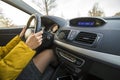 Modern car interior with driver female hands on steering wheel. Safe driving concept Royalty Free Stock Photo