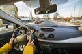 Modern car interior with driver female hands on steering wheel, winter snowy landscape outside. Safe driving concept Royalty Free Stock Photo