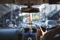 Modern car interior with hanging amulets charm on rear view mirror, driving on the road, selective focus Royalty Free Stock Photo