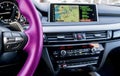 Modern car interior. Pink steering wheel with media phone control buttons. Navigation screen. Multimedia system background. Car in Royalty Free Stock Photo