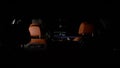 Modern car interior showing infotainment system and leather seats at night Royalty Free Stock Photo
