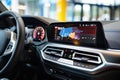 Modern car interior with a sleek dashboard, illuminated controls, and a digital navigation screen in focus