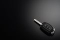 Modern car keys isolated on black reflective background