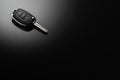 Modern car keys isolated on black reflective background