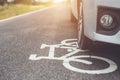 Modern car running on asphalt road / bicycle lane and tread on w Royalty Free Stock Photo