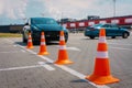 Modern car at test track, focus on traffic cones. Woman taking a driving test. Driving school Driving test, driver Royalty Free Stock Photo