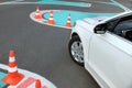 Modern car on test track with traffic cones, above view. Driving school Royalty Free Stock Photo