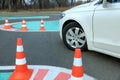 Modern car on test track with traffic cones, closeup. Driving school Royalty Free Stock Photo