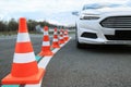 Modern car on test track with traffic cones, closeup. Driving school Royalty Free Stock Photo