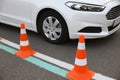 Modern car on test track with traffic cones, closeup. Driving school Royalty Free Stock Photo