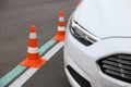 Modern car on test track with traffic cones, closeup. Driving school Royalty Free Stock Photo