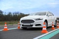 Modern car on test track with traffic cones. Driving school Royalty Free Stock Photo