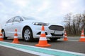 Modern car on test track with traffic cones, low angle view. Driving school Royalty Free Stock Photo