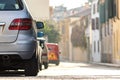 Modern cars parked on city street side in residential discrict. Shiny vehicles parked by the curb. Urban transportation