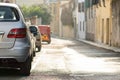 Modern cars parked on city street side in residential discrict. Shiny vehicles parked by the curb. Urban transportation