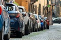 Modern cars parked on city street side in residential discrict. Shiny vehicles parked by the curb. Urban transportation