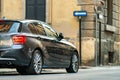 Modern cars parked on city street side in residential discrict. Shiny vehicles parked by the curb. Urban transportation