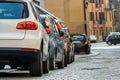 Modern cars parked on city street side in residential discrict. Shiny vehicles parked by the curb. Urban transportation