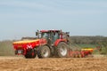 Modern case tractor drilling seed in field with vaderstad drill
