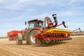 Modern case tractor drilling seed in field with vaderstad drill Royalty Free Stock Photo