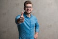 Modern casual man giving a thumbs up and smiling Royalty Free Stock Photo