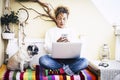 Modern caucasian middle age woman work at home with phone and laptop computer with her lovely pug dog - people and aminals Royalty Free Stock Photo