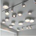 A modern ceiling features an array of circular recessed and track lighting fixtures, Royalty Free Stock Photo