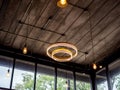 Modern ceiling light and light bulbs hanging from wooden ceiling in loft style building Royalty Free Stock Photo