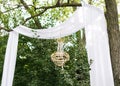 Modern celebration outdoor decoration. Destination elopement festive concept. Wedding arch made of white cotton fabric, decorated Royalty Free Stock Photo