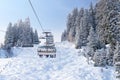 Modern chair lift in the skiing resort during winter vacation Royalty Free Stock Photo