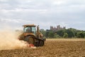 Modern Challenger tractor cultivating English crop field