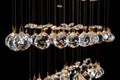 Modern Chandelier for interior of the living room. a bunch of crystal balls isolated on black background. Royalty Free Stock Photo
