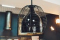 modern chandelier with seven round plafonds with lamps inside them against black background. electric fixture with round