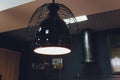 modern chandelier with seven round plafonds with lamps inside them against black background. electric fixture with round