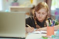 Modern child having distance education at home in sunny day Royalty Free Stock Photo